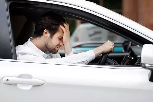 Man driving car despair after accident. Is he from a state with the worst drivers in Australia?