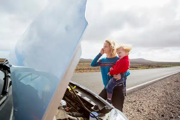 Mother and daughter with broken down car. It's important to know who to call when your car breaks down,