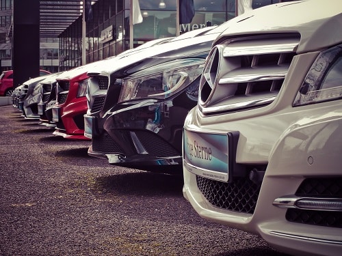 A row of cars. Their insurance may include Car insurance exclusions