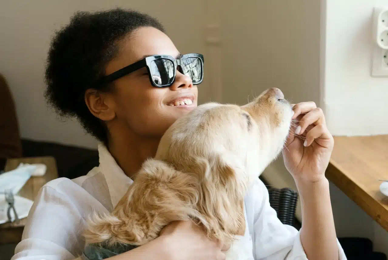 A Golden Retriever supports a woman with blindness in her daily activities and is known for being one of the top guide dog breeds.