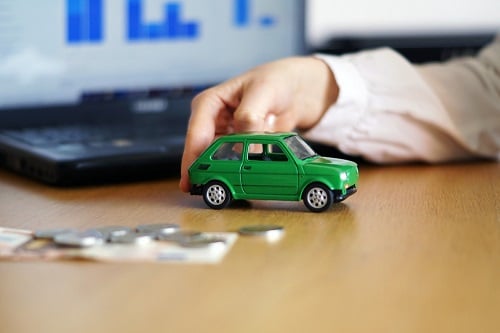 Closeup shot of a person thinking of buying a new car or selling a vehicle. You may be wondering about affordable cars and what car can I afford