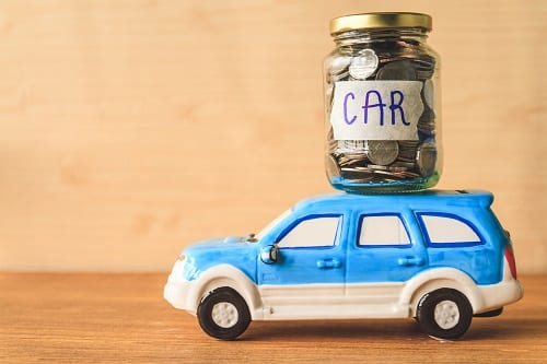 Glass jar of coins to save up for a new vehicle