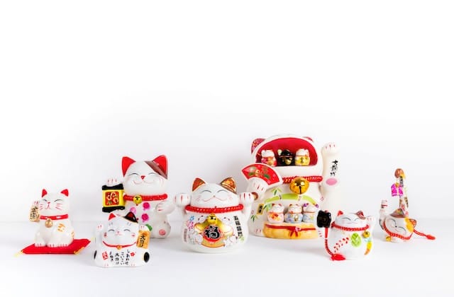 white red and yellow ceramic maneki neko figurines