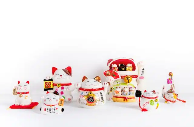 white red and yellow ceramic maneki neko figurines