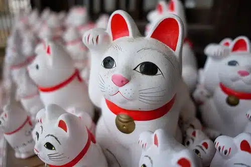 Soft focus shot of a dusty japanese lucky money cat (maneki-neko)