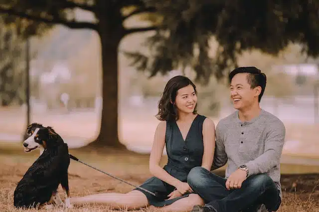 A couple smile after searching pet plans and signing up their dog to what they are confident is the best pet insurance in Australia