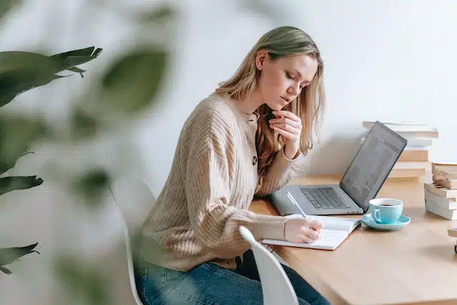 A woman researches different car insurance providers to compare cost 