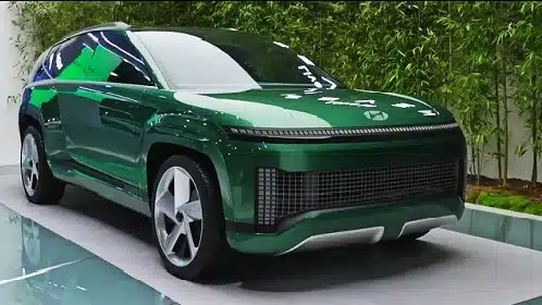 A green suv is on display at an auto show.