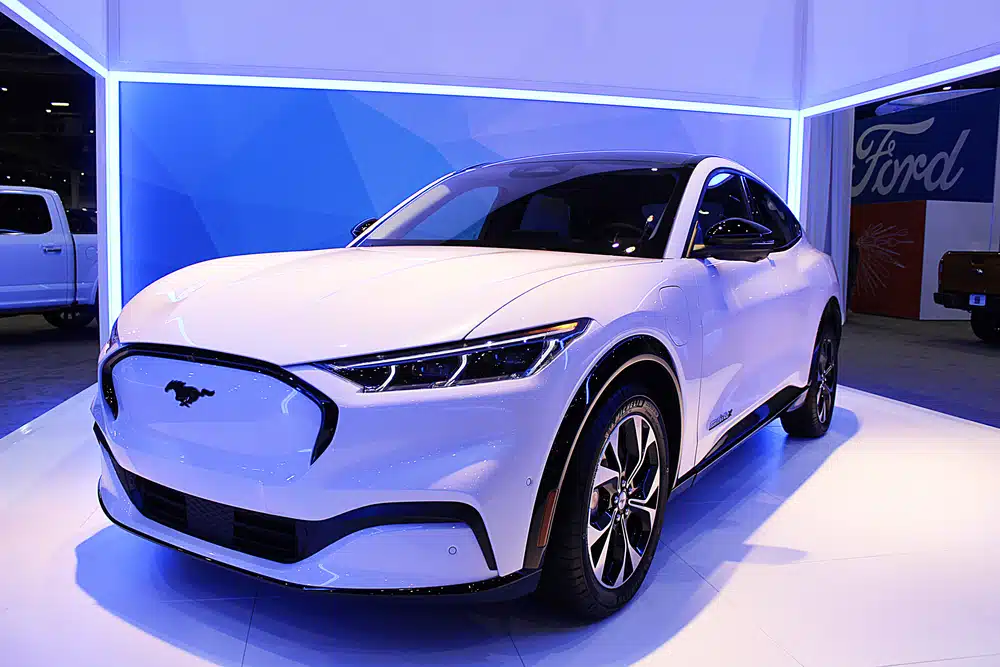 A white ford suv is on display at an auto show featuring new cars 2024.