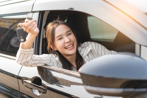 A woman buys a used car after getting a car history check that gives it the all clear