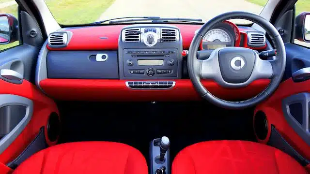 A "used car" with a red and black interior.
