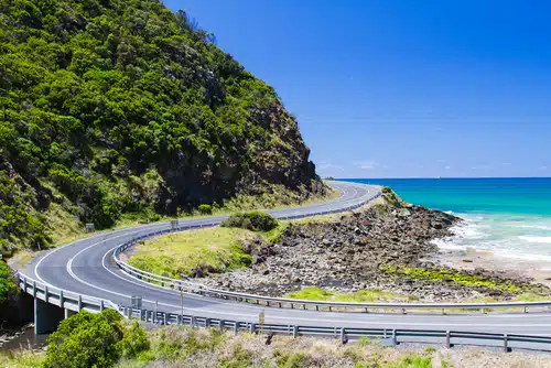 Embark on an Easter road trip along this coastal road, which curves gracefully beside a rocky shoreline. With greenery on one side and a breathtaking turquoise ocean on the other, the scene rivals even the beauty of Australia's Great Ocean Road under a clear blue sky.