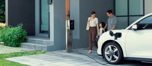 A mum, dad and daughter heads out their home to drive to school and work in their zero emission vehicle