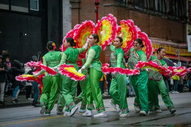 Performers in green costumes, celebrating the Chinese New Year of the Snake