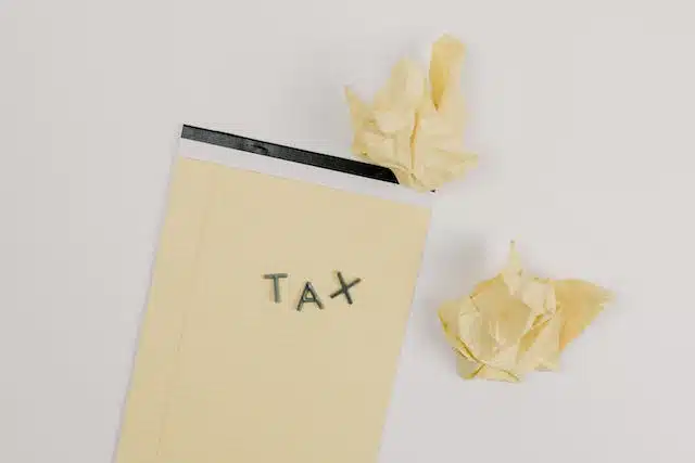 A piece of paper with the word tax written on it, specifically referring to Luxury Car Tax (LCT) in Australia.