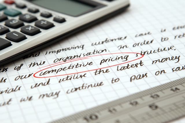 A calculator on a page with details about car insurance to find the best of competitive pricing written on it.