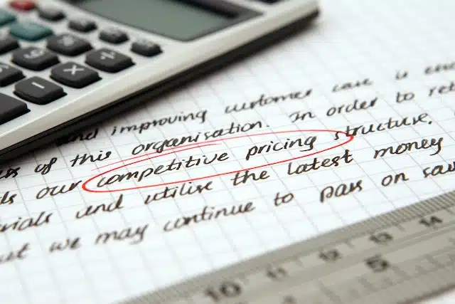 A calculator on a page with details about car insurance to find the best of competitive pricing written on it.