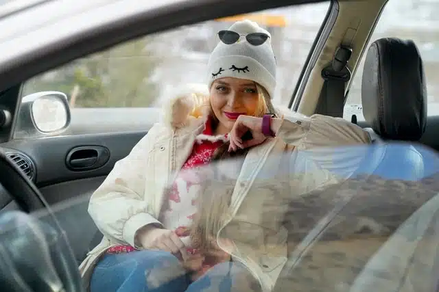 A woman in a white hat sitting in a car on a chilly morning in Australia
