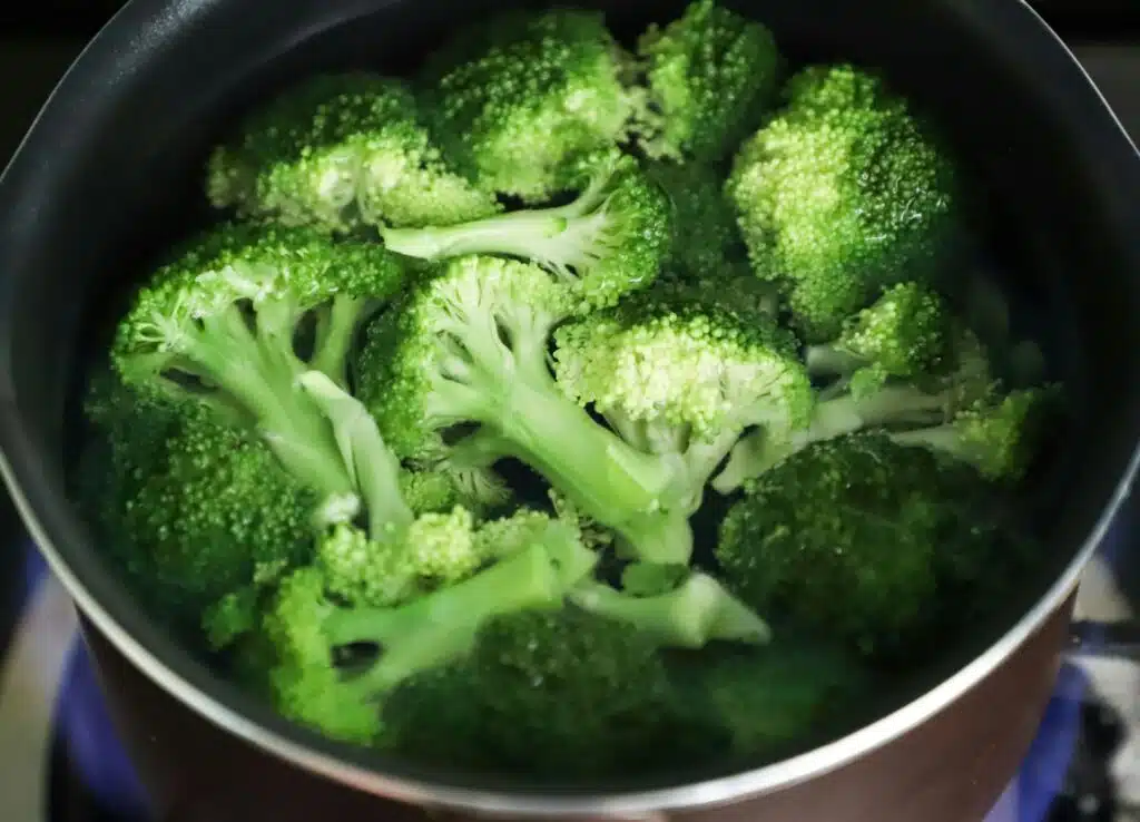 A pot of cooked broccoli.