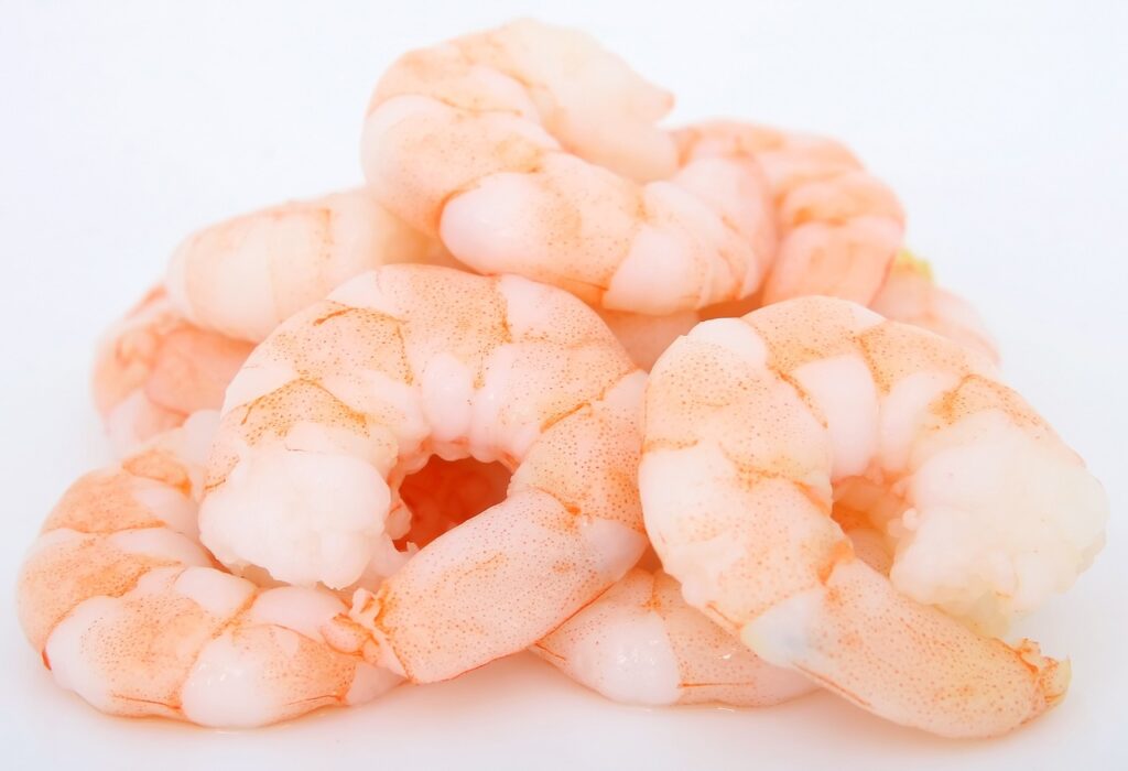 A pile of shrimp on a white surface.