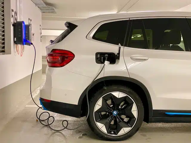 An electric car being charged at a charging station.