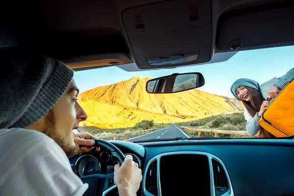 Inside the car, a man drives carefully.