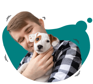 A person in a plaid shirt is holding a small white and brown dog while smiling, capturing the essence of dogs from the west.